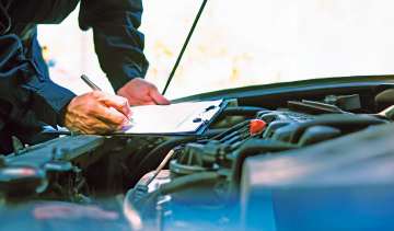 Mechanic inspecting a car's engine bay
