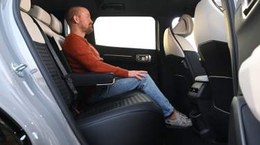 Kia EV4 - rear seats being sat in by former Auto Express chief review, Alex Ingram 