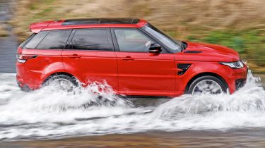 Range Rover driving through ford