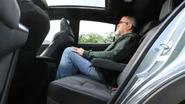 Toyota C-HR+ - rear seats being sat in by Auto Express senior test editor, Dean Gibson