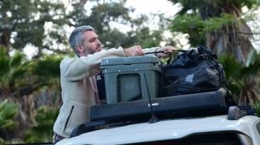 Auto Express deputy editor Richard Ingram removing luggage from the Dacia Duster&#039;s roof rack