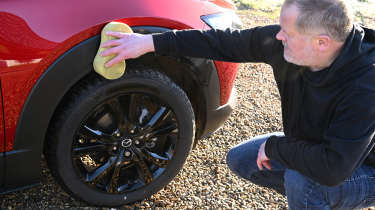 Auto Express executive editor Paul Adam washing the Mazda CX-30