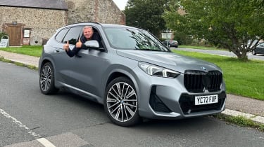 Auto Express special contributor Steve Sutcliffe giving a thumbs up pose out of the window of the BMW X1