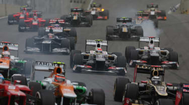 The two Saubers of Sergio Perez and Kamui Kobayashi attack on the first corner of the Brazilian Grand Prix