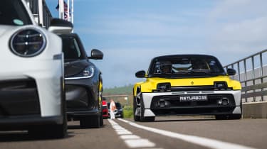 Renault 5 Turbo 3E passing a Porsche 911
