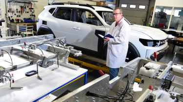 John McIlroy standing next to a Dacia Duster bodyshell