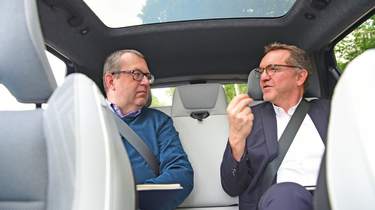 Out-going Renault UK boss Guillaume Sicard and John McIlroy talking in the back of a Renault Scenic