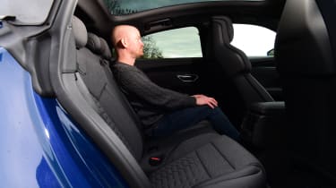 Auto Express chief reviewer Alex Ingram sitting in the back seat of the Audi RS e-tron GT