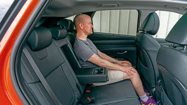 Hyundai Tucson Hybrid - rear seats with Auto Express chief reviewer Alex Ingram 