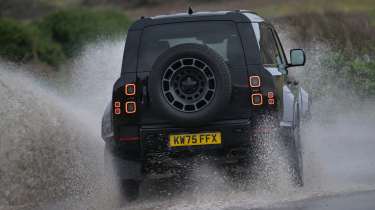 Land Rover Defender OCTA Black - rear cornering (wet)