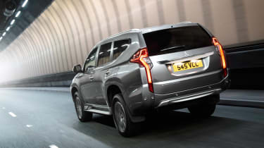 Mitsubishi Shogun Sport seen from the rear driving in a tunnel