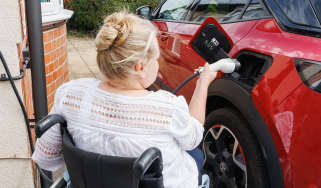 Person in wheelchair plugging in car Alistair Veryard photography