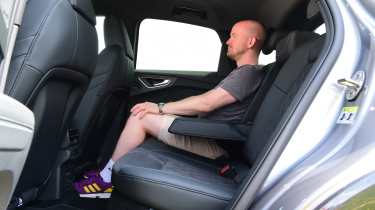 Auto Express chief reviewer Alex Ingram sitting in the Audi Q4 e-tron Sportback&#039;s back seat