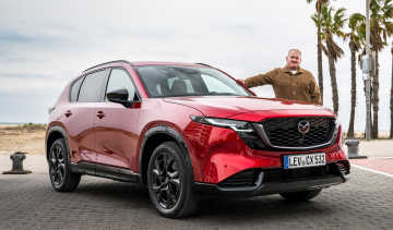 Auto Express news reporter Ellis Hyde standing next to a Mazda CX-5