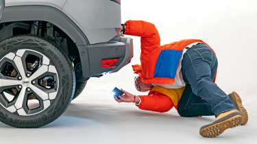 Dacia owner inspecting the Dacia Duster&#039;s rear bumper