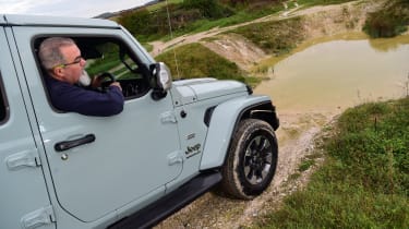 Auto Express senior test editor Dean Gibson leaning out of a Jeep Wrangler&#039;s driver&#039;s window