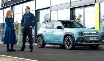 Auto Express pictures editor Dawn Grant and Renault sales executive Jamie Collis standing next to the Renault 4