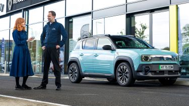 Auto Express pictures editor Dawn Grant and Renault sales executive Jamie Collis standing next to the Renault 4