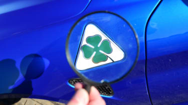 Alfa Romeo Giulia Quadrifoglio - Cloverleaf badge (through magnifying glass)