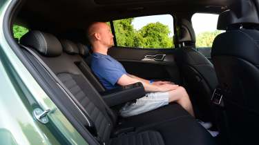 Kia Sportage - rear seats being sat in by Auto Express chief reviewer Alex Ingram 