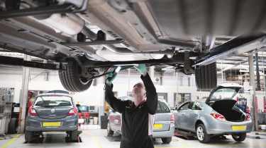 Vauxhall technician working on car