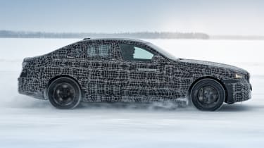 Camouflaged BMW i5 winter testing (official picture) - side action