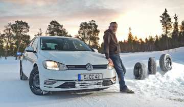 Auto express product tester John Barker standing next to a Volkswagen Golf