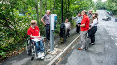 EV drivers surrounding a charging point