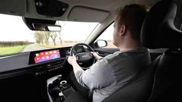 Kia EV6 - interior driving shot with News Reporter, Ellis Hyde