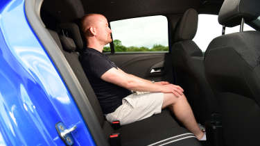 Auto Express chief reviewer Alex Ingram sitting in the Vauxhall Corsa&#039;s back seat
