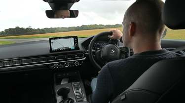 Auto Express chief reviewer Alex Ingram driving the Honda Civic