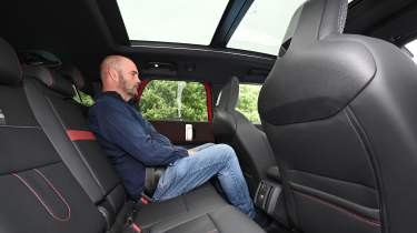 Auto Express creative director Darren Wilson sitting in the MINI Countryman JCW&#039;s back seat