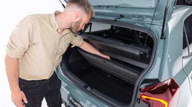 Charlie Harvey looking in the boot of the Kia Picanto