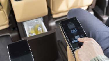 New Denza D9 - Auto Express senior news reporter Alastair Crooks adjusting the captain chairs via the touchscreen controls