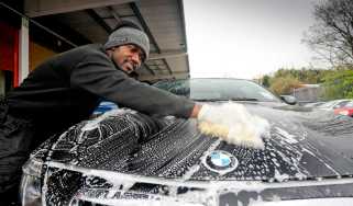 Man cleaning a BMW