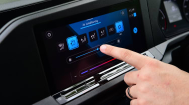 Auto Express senior road test editor Dean Gibson operating the Volkswagen Caddy Cargo&#039;s infotainment system 