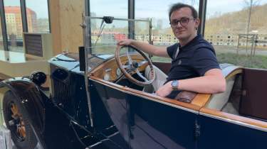 Auto Express consumer reporter Tom Jervis sitting in a vintage Volvo