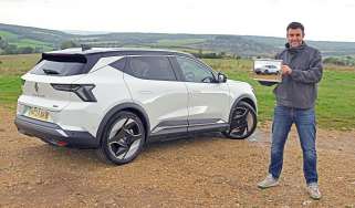 Auto Express head of digital content Steve Walker standing next to the Renault Scenic and holding a photograph of it