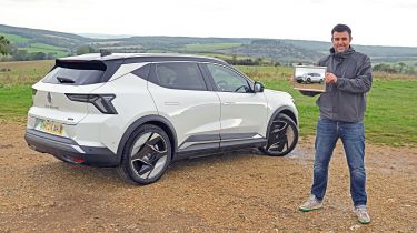 Auto Express head of digital content Steve Walker standing next to the Renault Scenic and holding a photograph of it