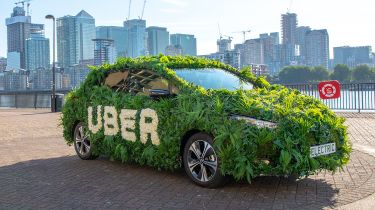 Grass covered Uber vehicle