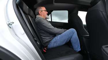Auto Express senior test editor Dean Gibson sitting in the Toyota C-HR's rear seat