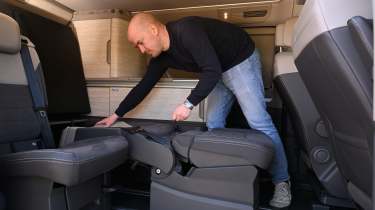 Volkswagen California - Auto Express chief reviewer, Alex Ingram, folding the rear seats into the bedding area 