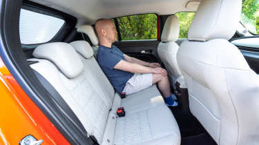 Auto Express chief reviewer Alex Ingram sitting in the Fiat 600e&#039;s back seat