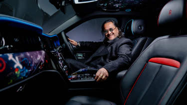 Cyril Kongo sitting inside the Rolls-Royce Black Badge Cullinan by Cyril Kongo