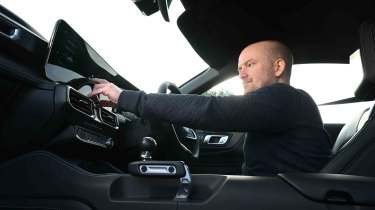 Ford Mustang GT - Chief reviewer, Alex Ingram operating the infotainment