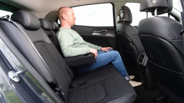 Auto Express chief reviewer Alex Ingram sitting in back seat of Kia Sportage