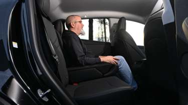 Auto Express senior road test editor Dean Gibson sitting in the Tesla Model Y's rear seat