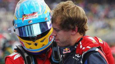 Fernando Alonso talks to Sebastian Vettel after the race