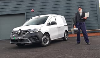 Auto Express senior road test editor Dean Gibson standing next to the Renault Kangoo in full work gear