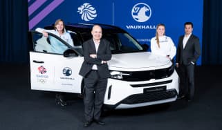 Team GB and Vauxhall representatives stood around a Vauxhall Frontera Electric
